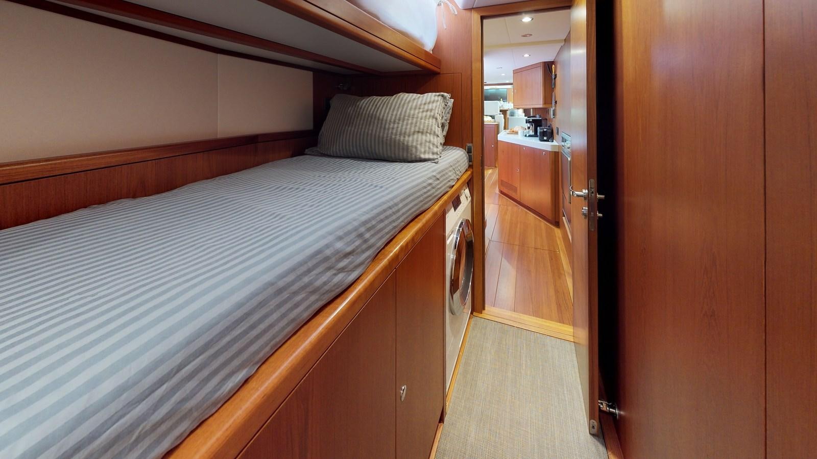 a bed in a room aboard AYNI Yacht for Sale