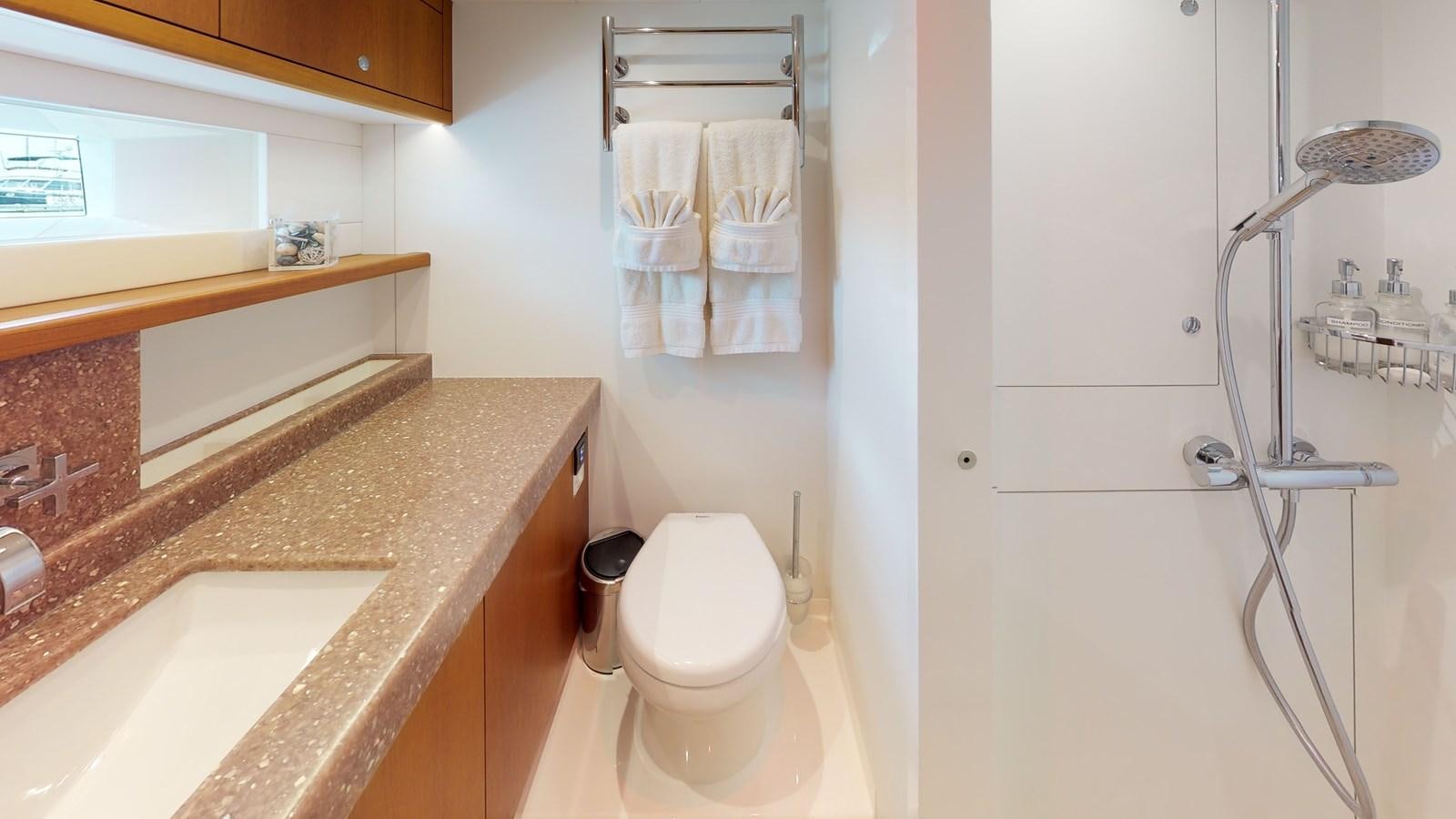 a bathroom with a sink and a toilet aboard AYNI Yacht for Sale