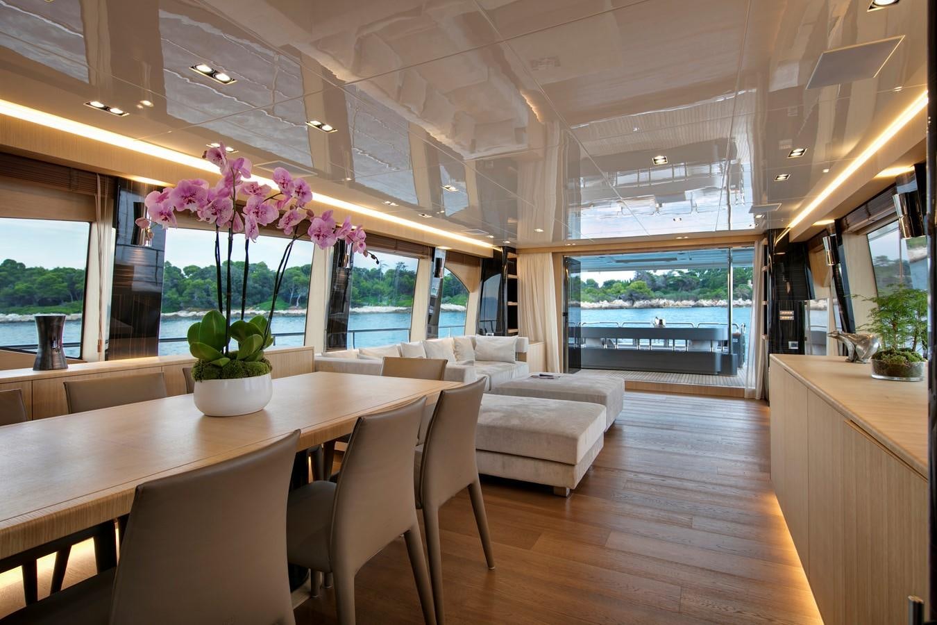 a room with a table chairs and plants in it aboard CANADOS 888 EVO Yacht for Sale