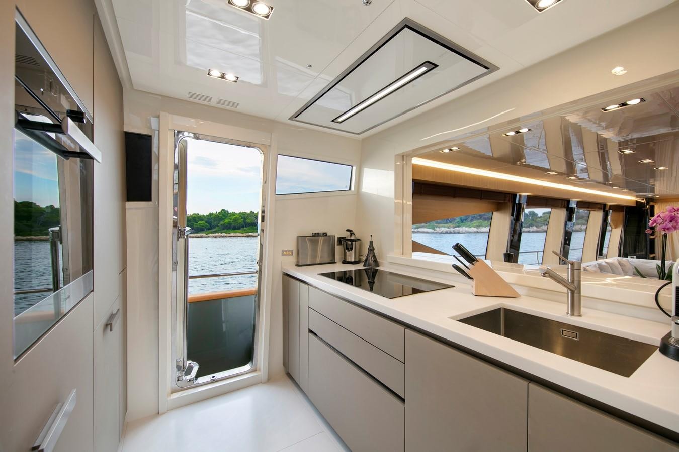 a kitchen with a large window aboard CANADOS 888 EVO Yacht for Sale