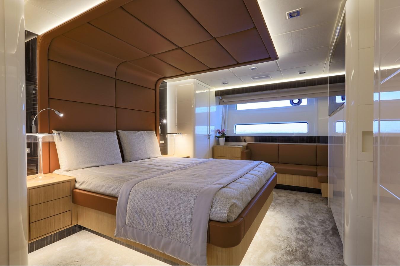 a room with a bed and a desk aboard CANADOS 888 EVO Yacht for Sale