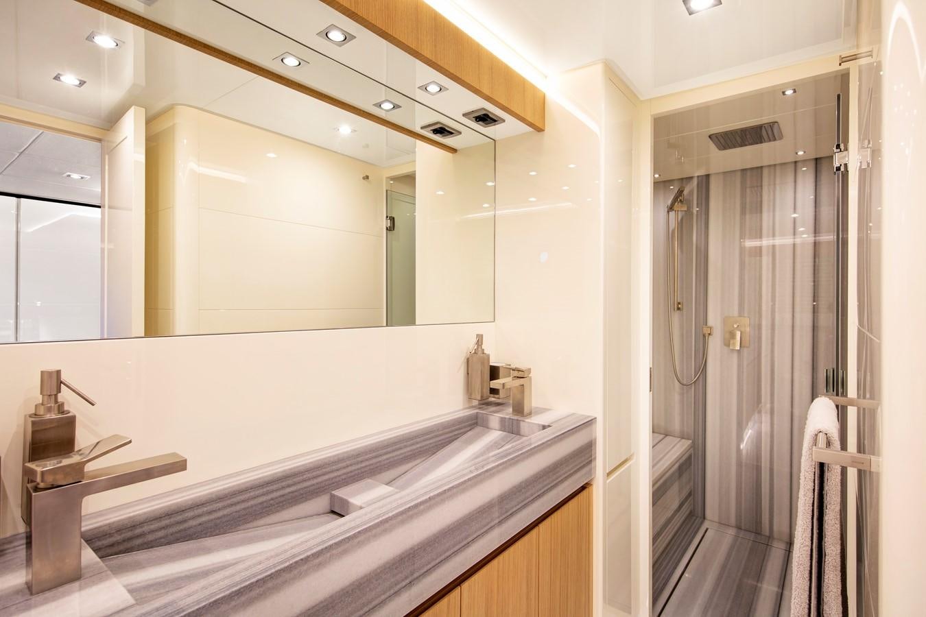 a bathroom with a countertop sink and mirror aboard CANADOS 888 EVO Yacht for Sale
