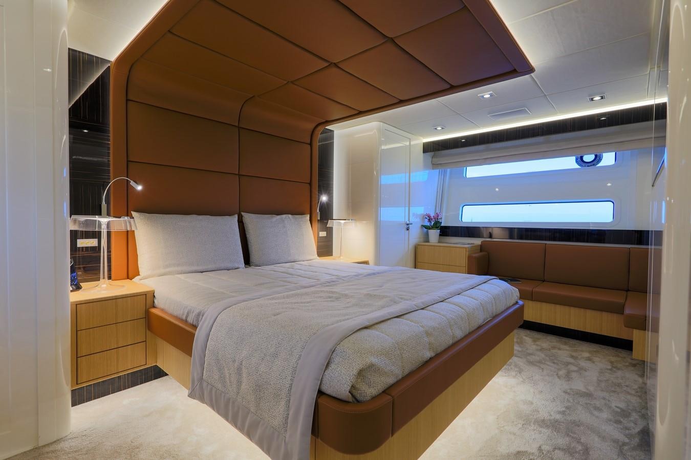 a room with a bed and a couch aboard CANADOS 888 EVO Yacht for Sale
