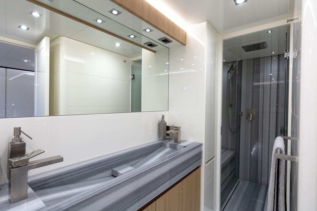 a bathroom with a large mirror aboard CANADOS 888 EVO Yacht for Sale