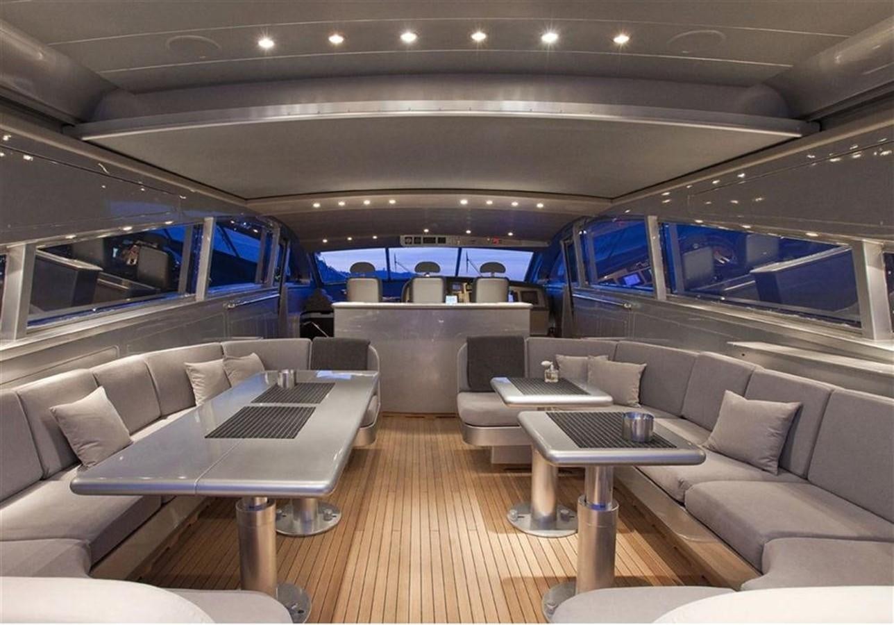 a room with a couch and a table with a laptop on it aboard ZAMBOANGA Yacht for Sale