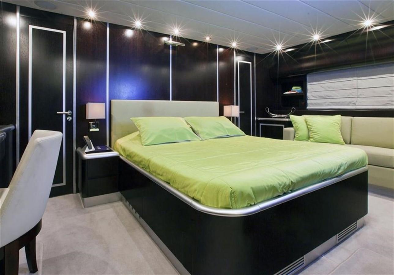 a bed with green sheets aboard ZAMBOANGA Yacht for Sale