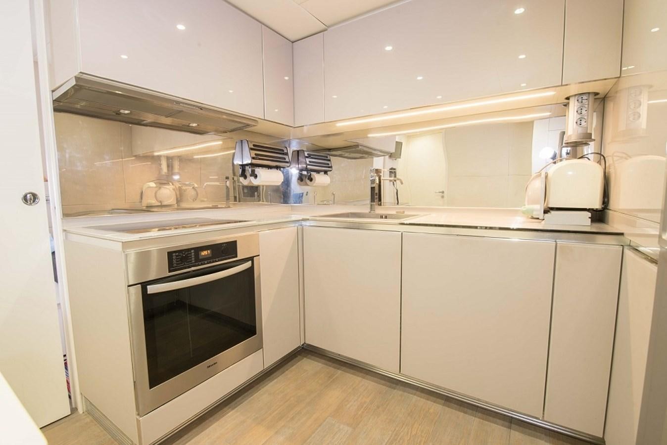 a kitchen with white cabinets aboard DORIS V Yacht for Sale