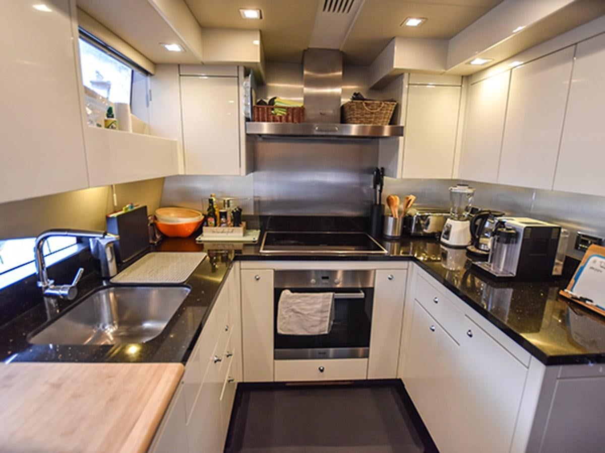 a kitchen with white cabinets aboard KYRENIA Yacht for Sale