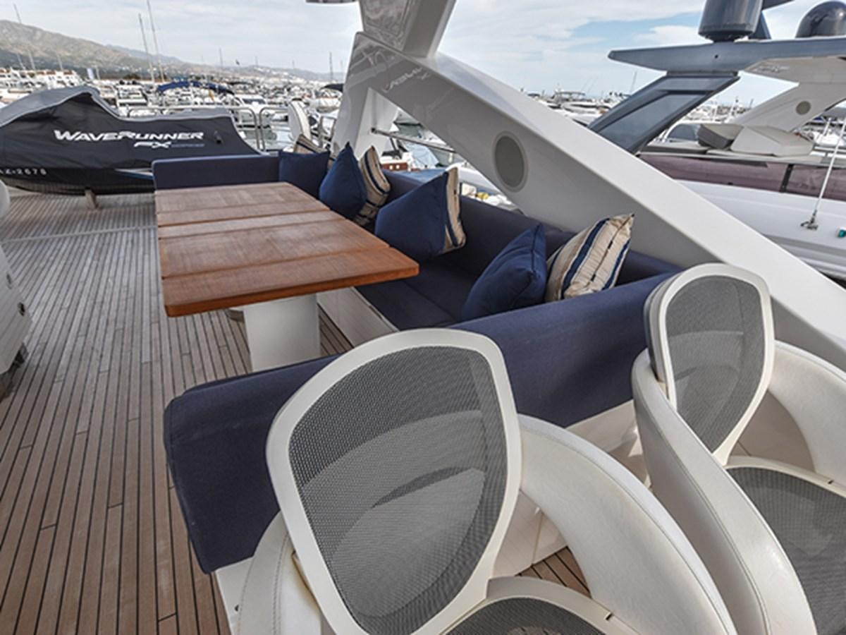 a deck with chairs and tables aboard KYRENIA Yacht for Sale