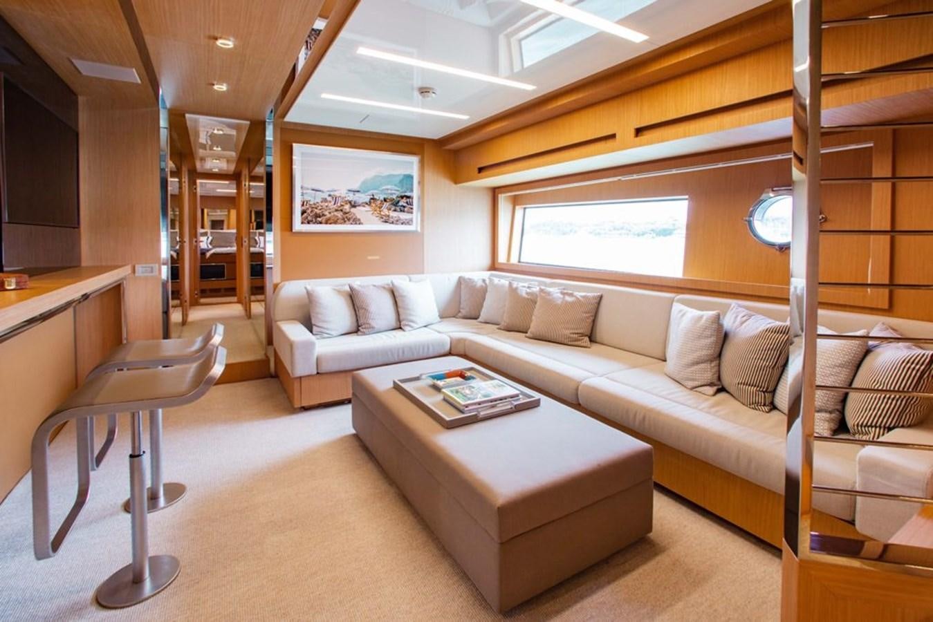 a living room with a couch and a coffee table aboard AMARA  Yacht for Sale