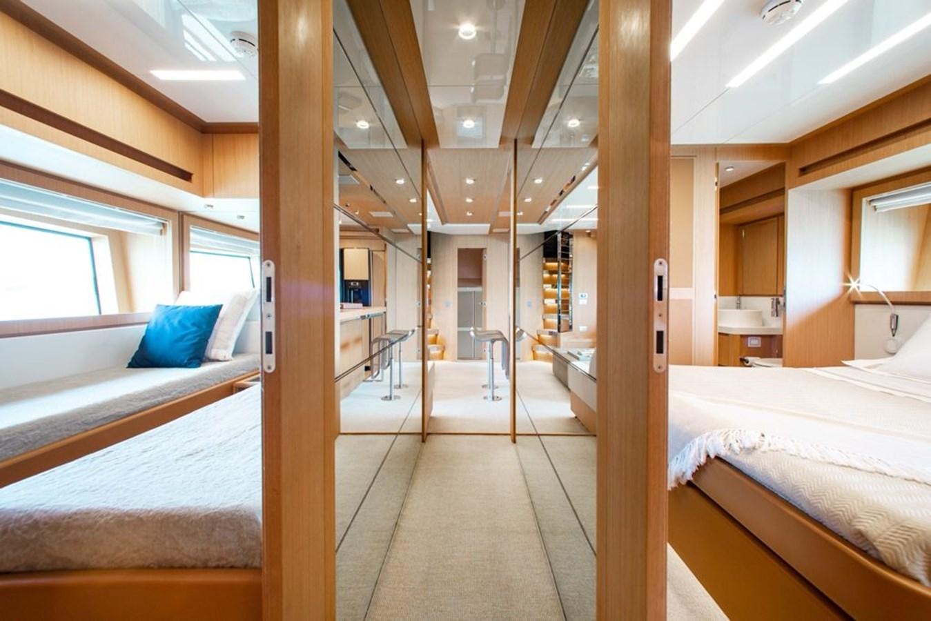 a room with beds and a wood door aboard AMARA  Yacht for Sale