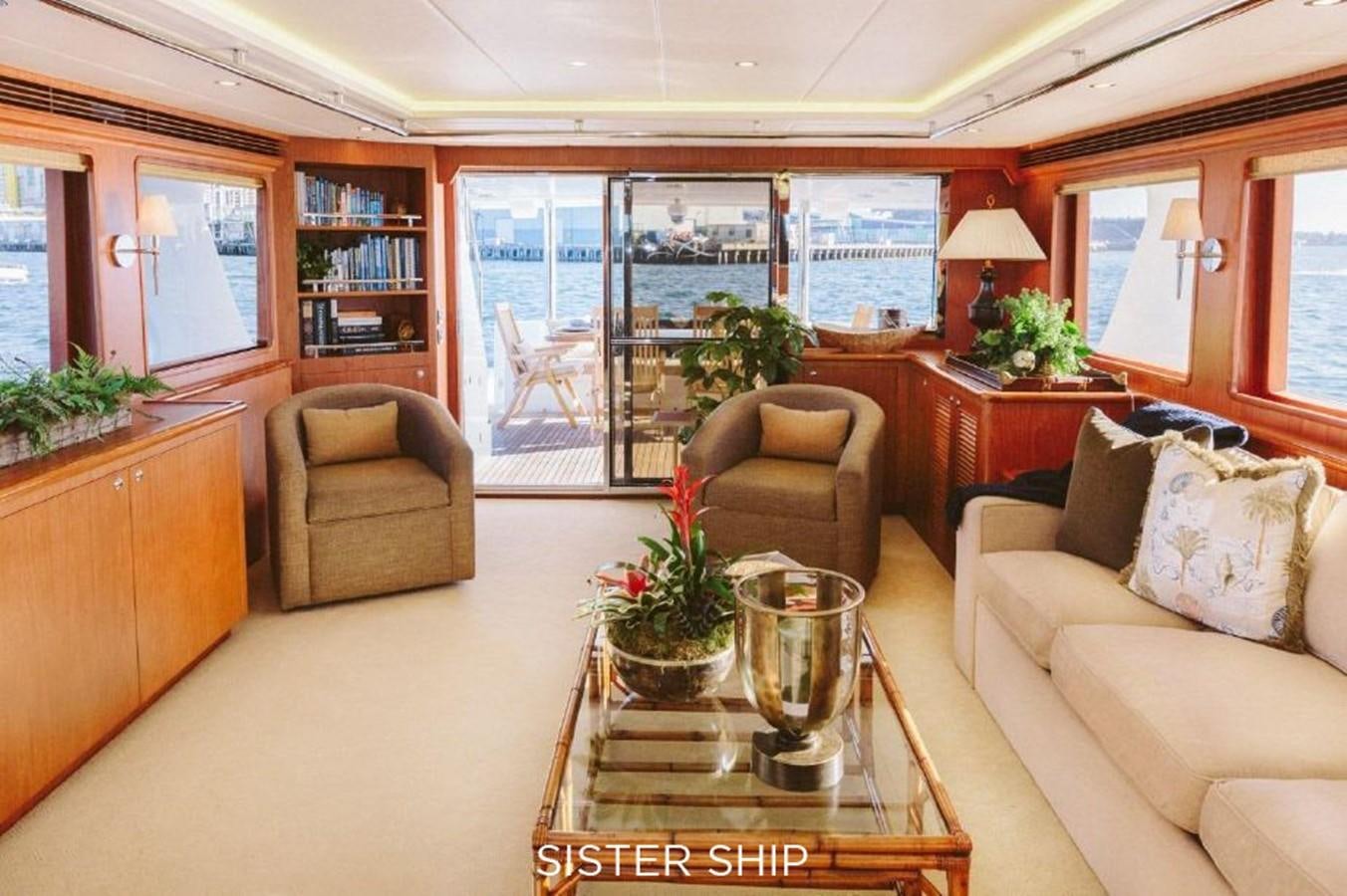 a living room with a glass coffee table and a view of the city aboard 880 CPMY Yacht for Sale