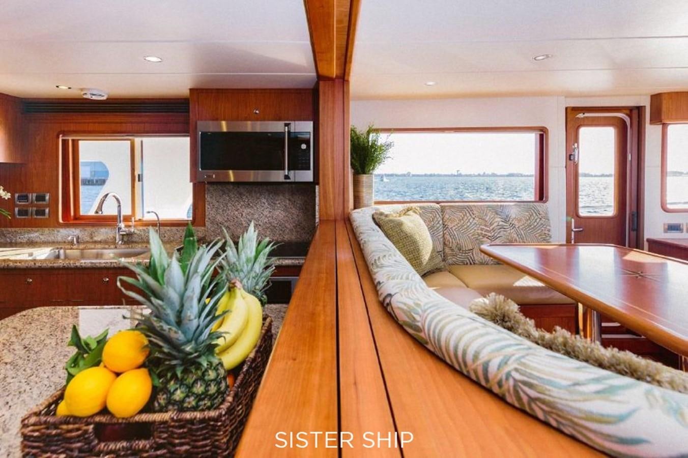a modern looking living room with a large open kitchen and dining area aboard 880 CPMY Yacht for Sale