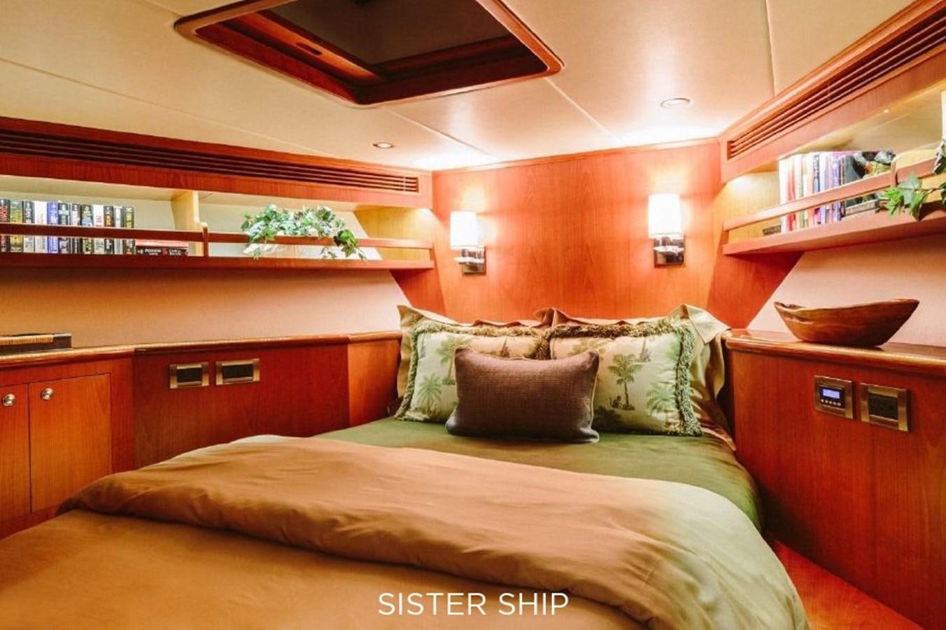 a bed with pillows and a shelf above it aboard 880 CPMY Yacht for Sale