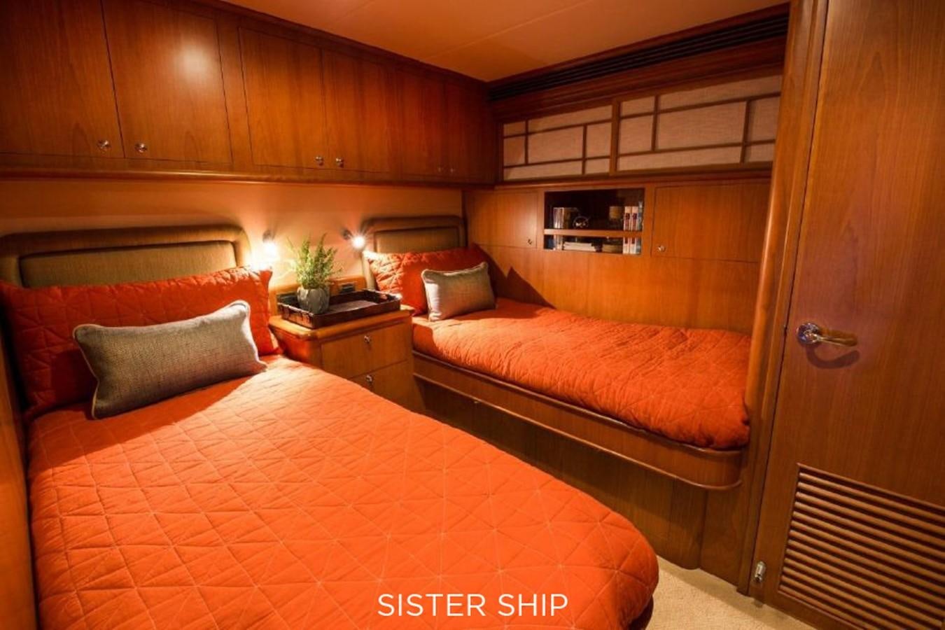 a room with a bed and a wood cabinet aboard 880 CPMY Yacht for Sale