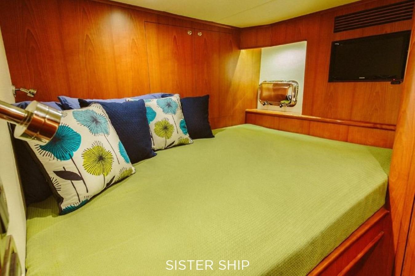 a bed with blue and white pillows aboard 880 CPMY Yacht for Sale