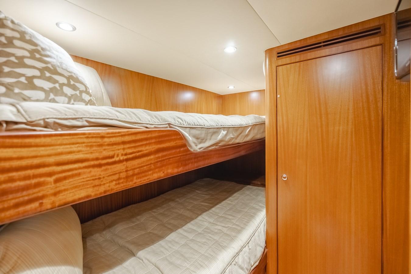 a bed with a wooden headboard aboard HAWK EYE  Yacht for Sale