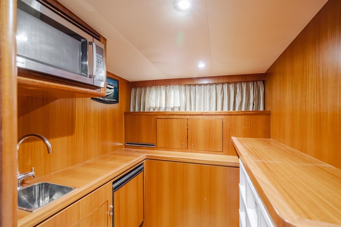 a kitchen with wooden cabinets aboard HAWK EYE  Yacht for Sale
