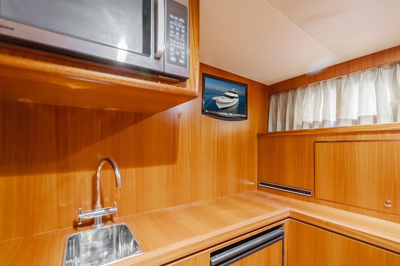 a kitchen with wooden cabinets aboard HAWK EYE  Yacht for Sale