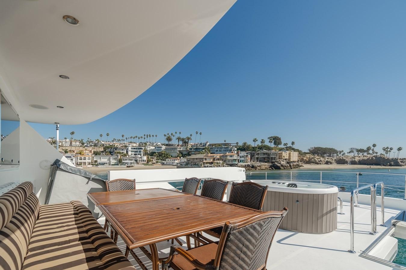 a table and chairs on a patio aboard HAWK EYE  Yacht for Sale