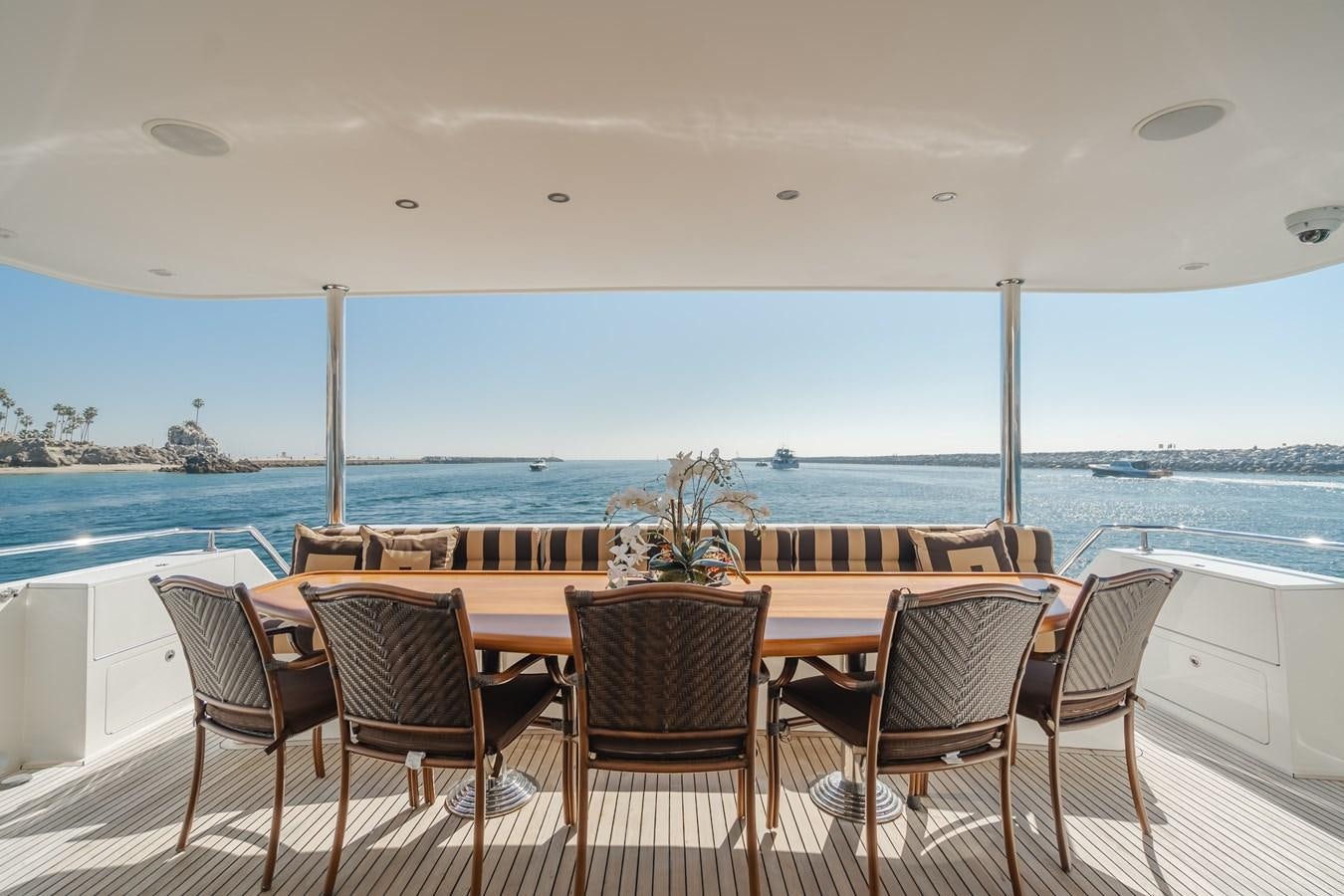 a table and chairs on a balcony aboard HAWK EYE  Yacht for Sale
