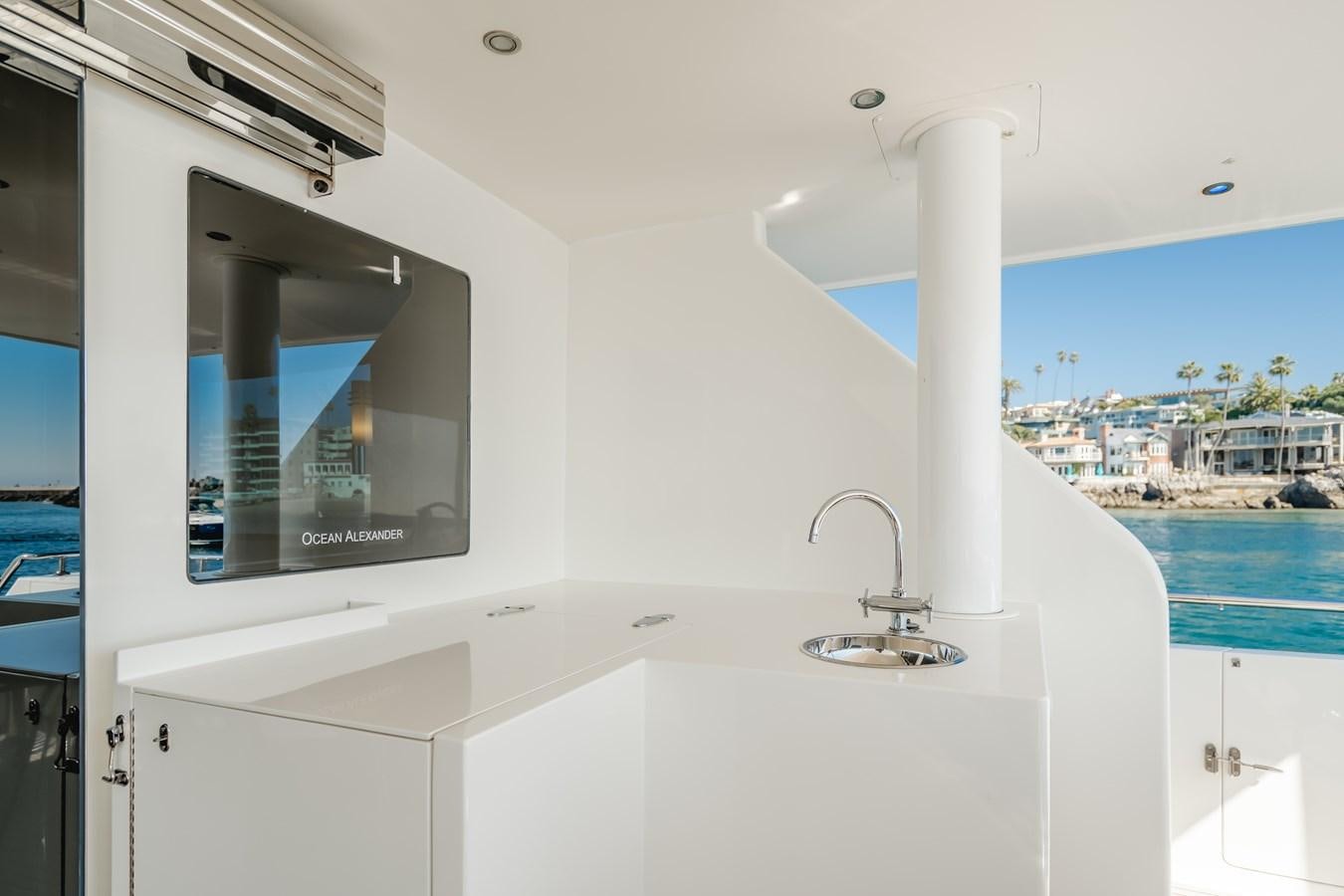 a white kitchen with a large window aboard HAWK EYE  Yacht for Sale