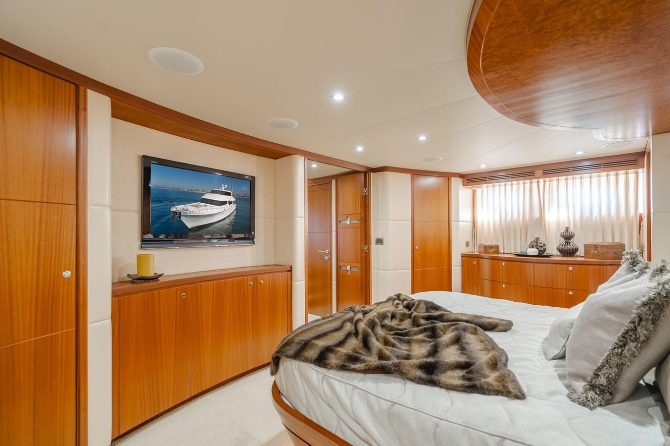 a bedroom with a large television aboard HAWK EYE  Yacht for Sale