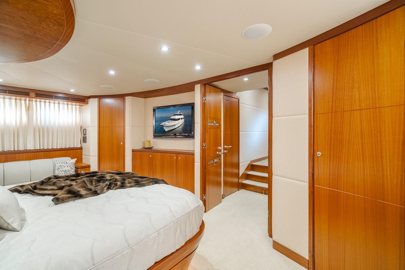 a bedroom with a bed and a television aboard HAWK EYE  Yacht for Sale
