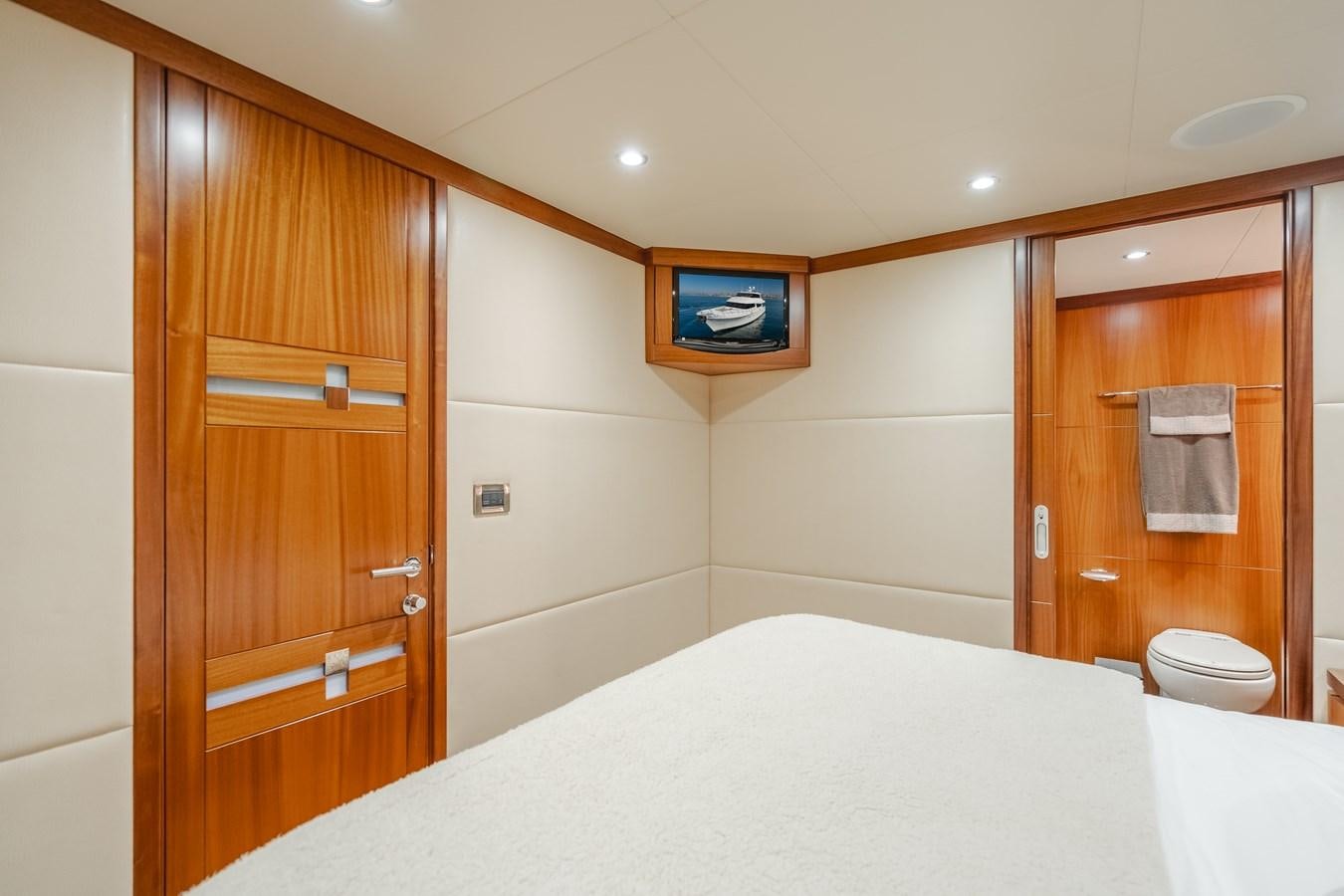a bathroom with a bed and a television aboard HAWK EYE  Yacht for Sale