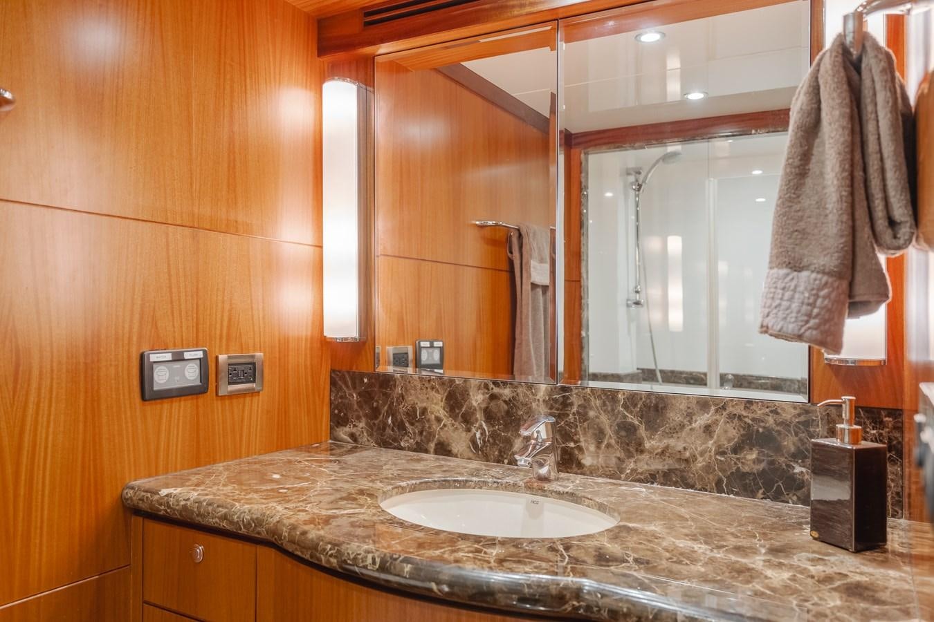a bathroom with a countertop sink and a mirror aboard HAWK EYE  Yacht for Sale