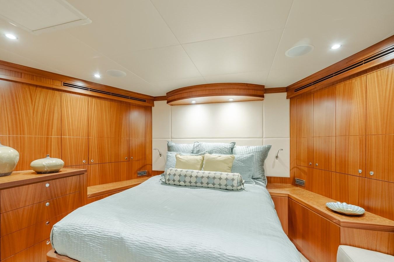 a bedroom with a bed and a desk aboard HAWK EYE  Yacht for Sale
