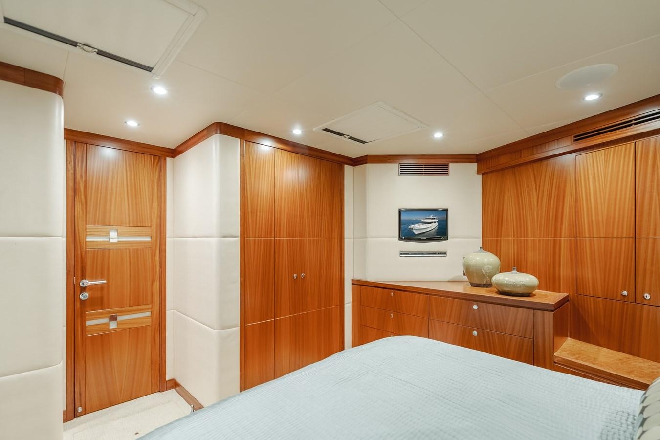 a bedroom with wood cabinets aboard HAWK EYE  Yacht for Sale