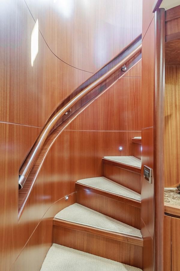 a wooden staircase with a wood railing aboard HAWK EYE  Yacht for Sale