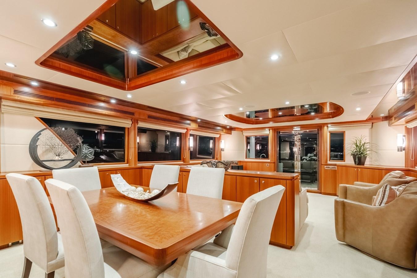 a room with a table chairs and a couch aboard HAWK EYE  Yacht for Sale