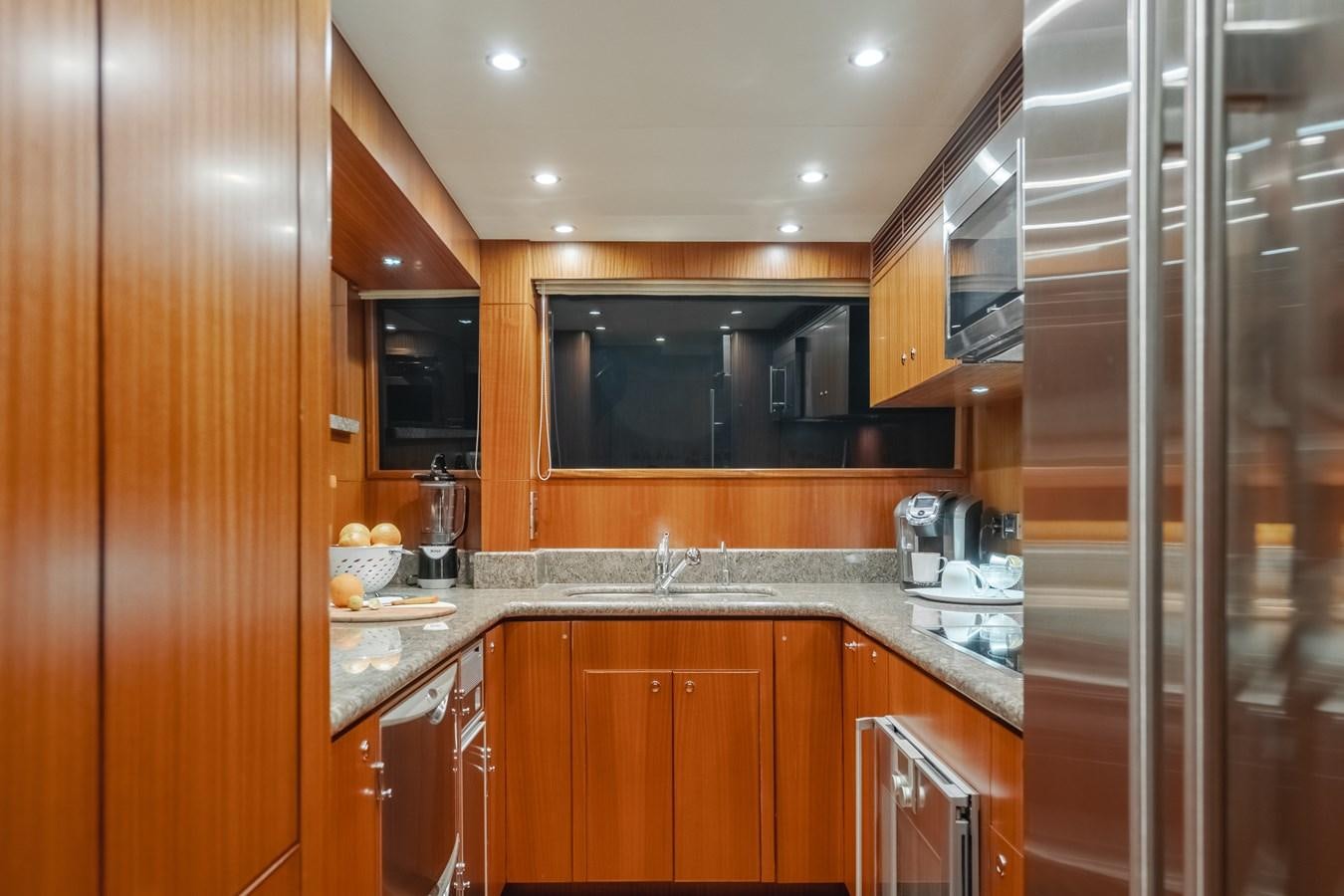 a kitchen with wooden cabinets aboard HAWK EYE  Yacht for Sale