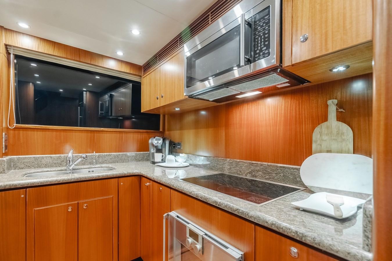 a kitchen with wooden cabinets aboard HAWK EYE  Yacht for Sale