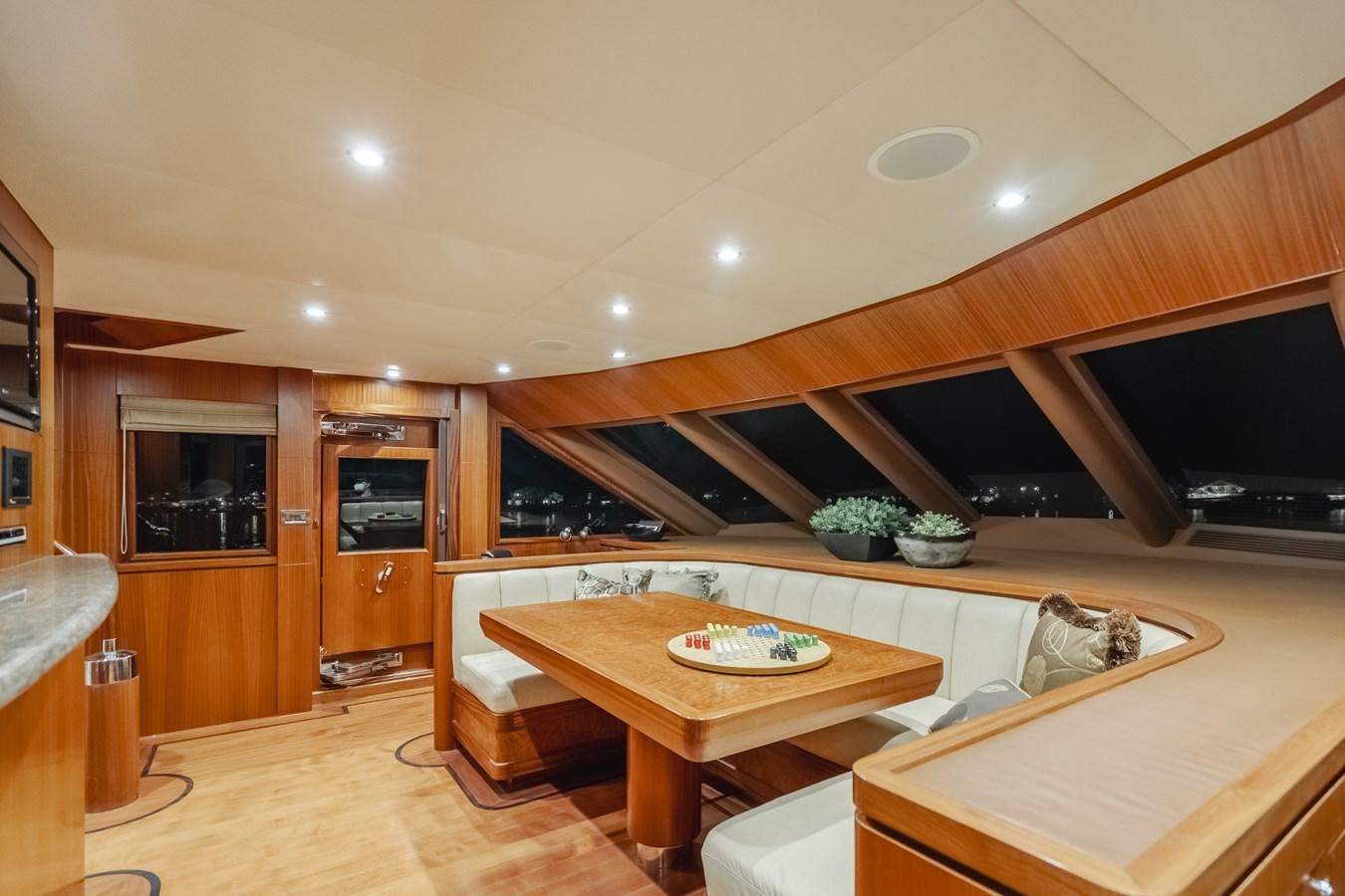a kitchen with a table and a tv aboard HAWK EYE  Yacht for Sale