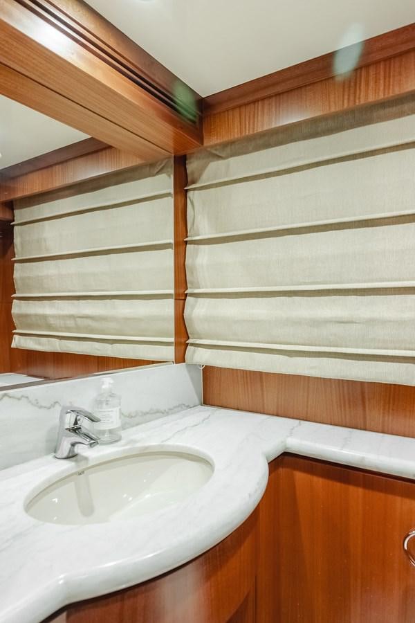 a bathroom with a sink and a wooden shelf aboard HAWK EYE  Yacht for Sale