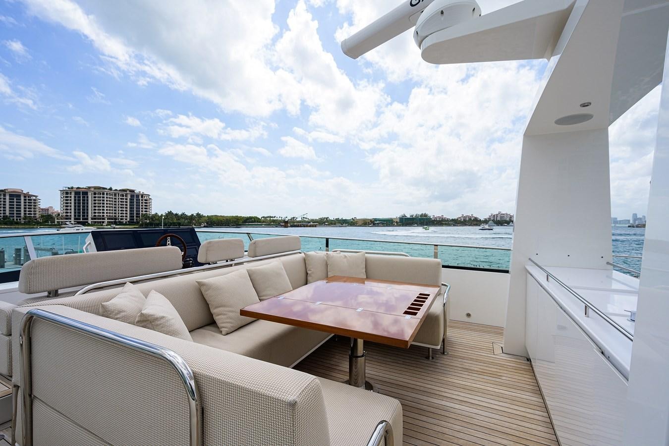 a room with a couch and a table and chairs on a deck aboard CHREEDO Yacht for Sale