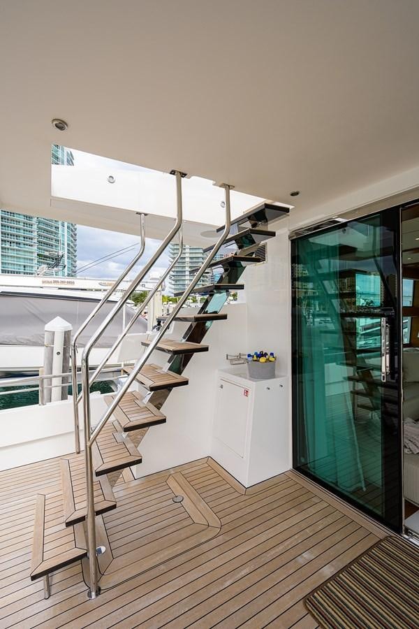 a white kitchen with a glass door aboard CHREEDO Yacht for Sale