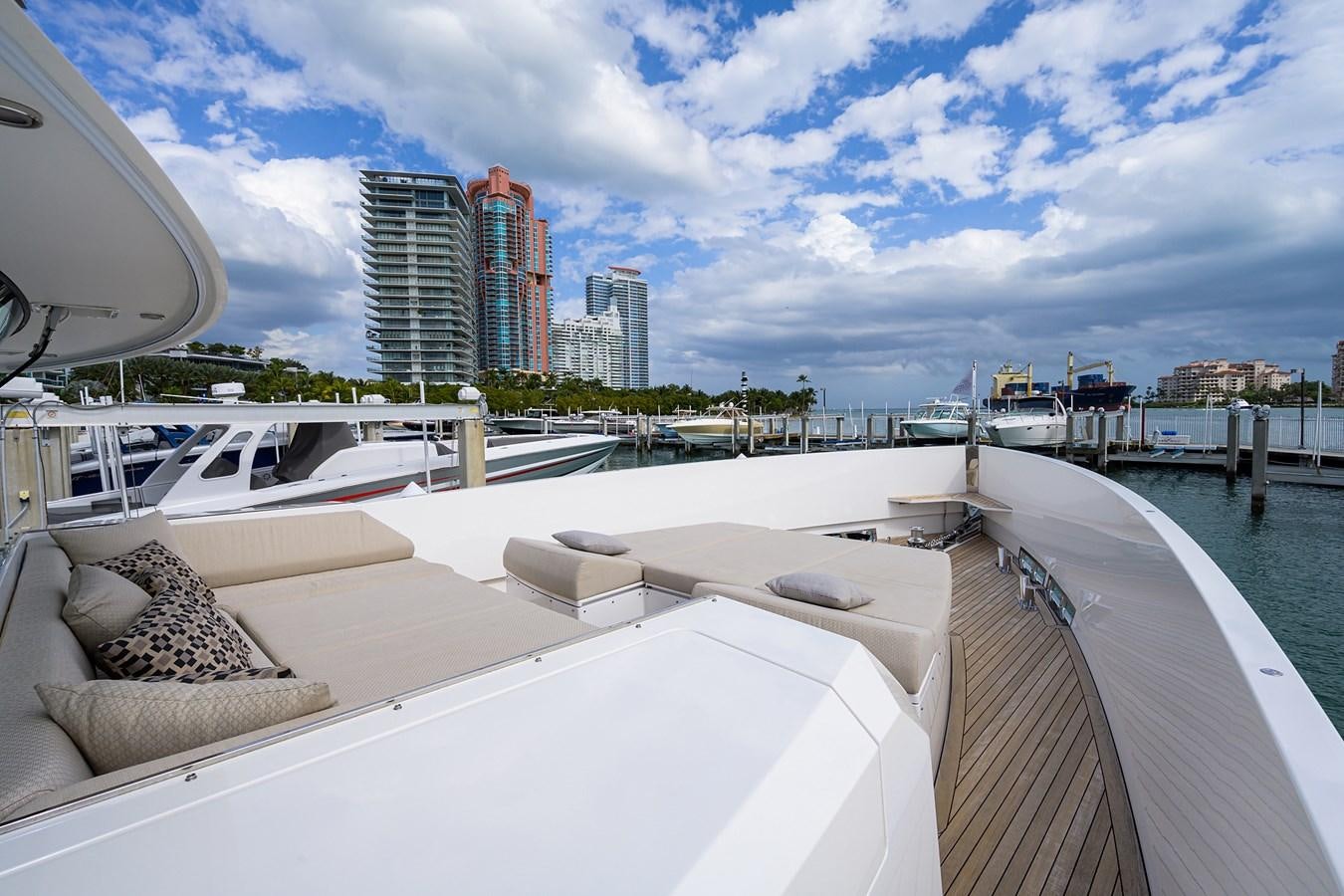 a deck with a view of a city and a body of water aboard CHREEDO Yacht for Sale