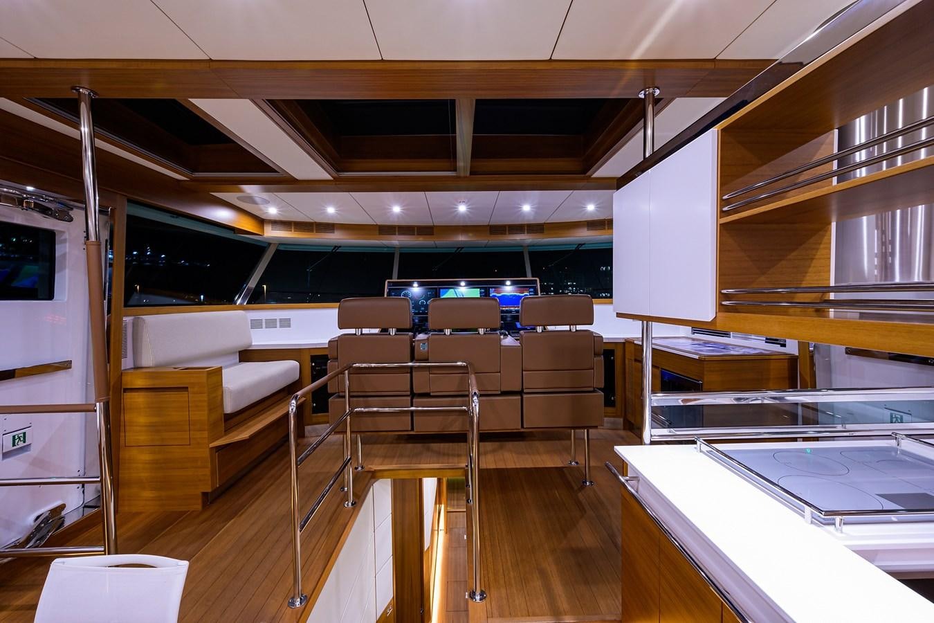 a room with tables and chairs aboard CHREEDO Yacht for Sale