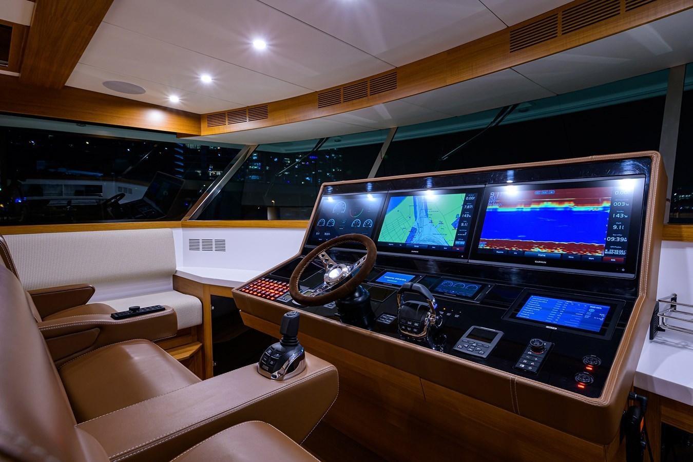 a room with a large television and a table with chairs aboard CHREEDO Yacht for Sale