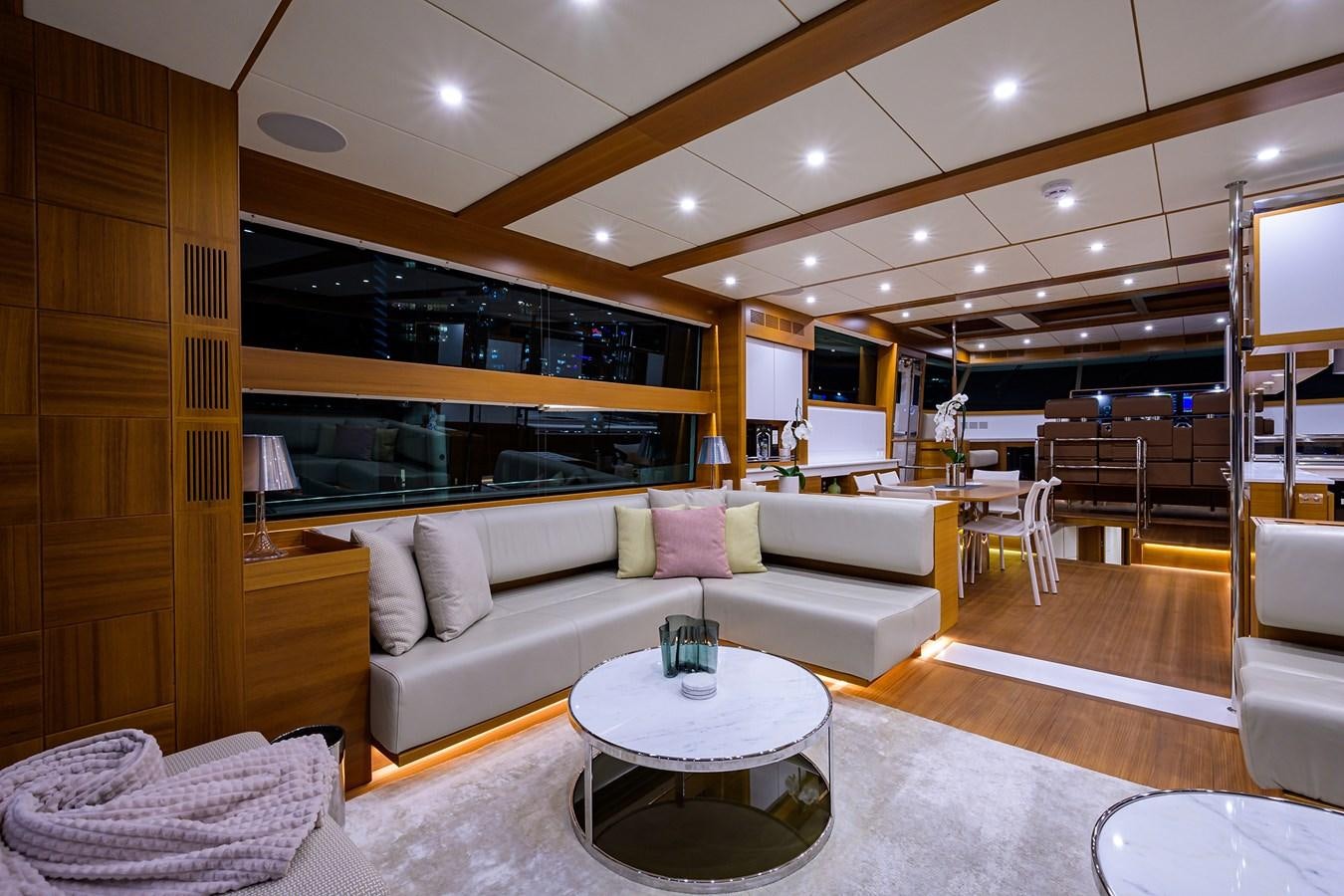 a living room with a couch and a table aboard CHREEDO Yacht for Sale