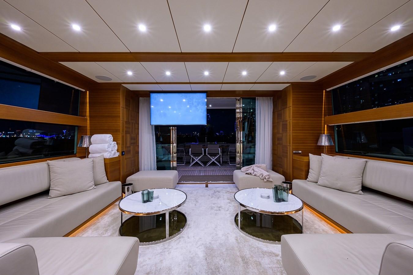 a living room with a large screen aboard CHREEDO Yacht for Sale