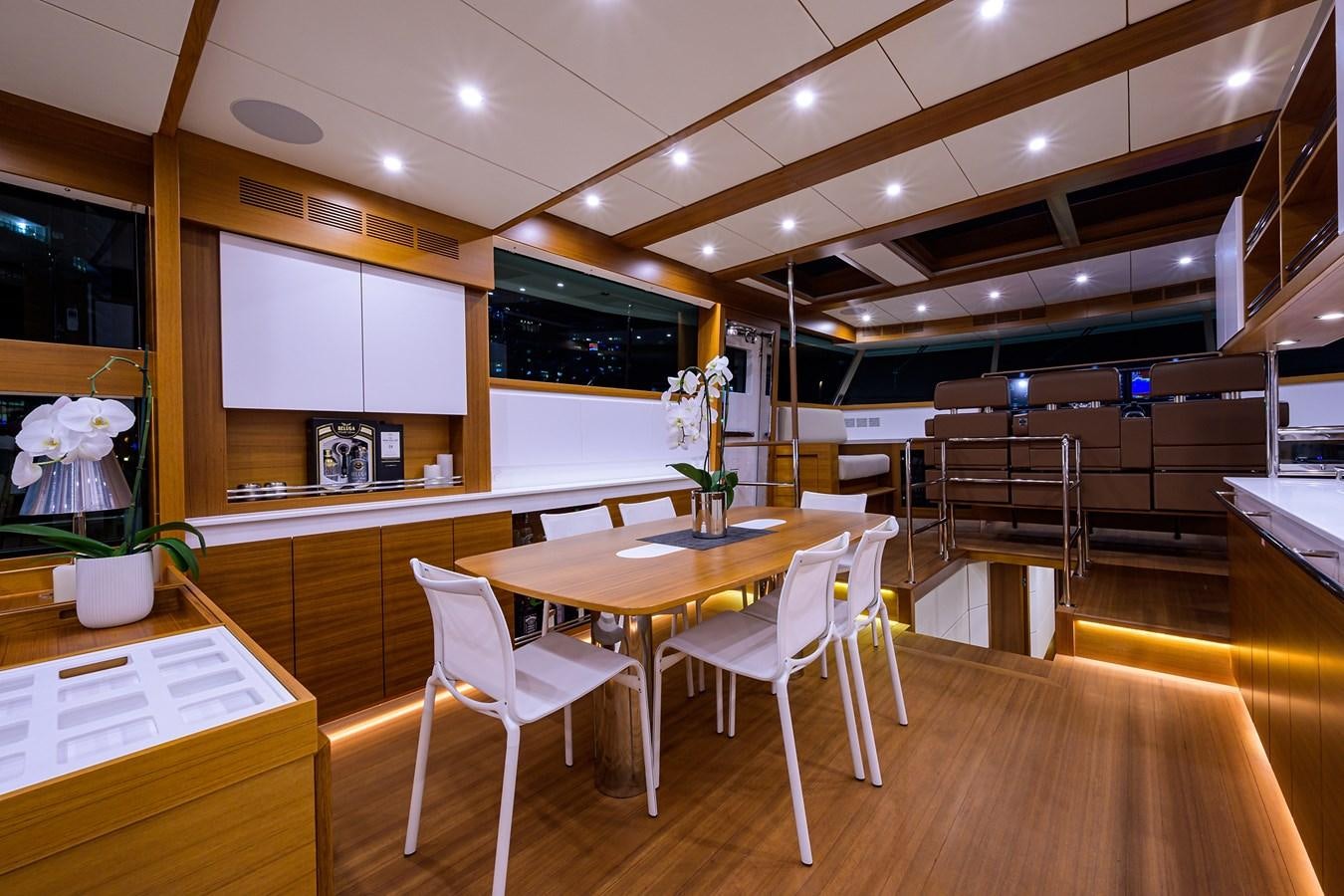 a room with a table and chairs aboard CHREEDO Yacht for Sale