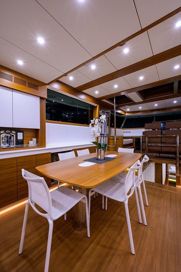 a table and chairs in a room aboard CHREEDO Yacht for Sale