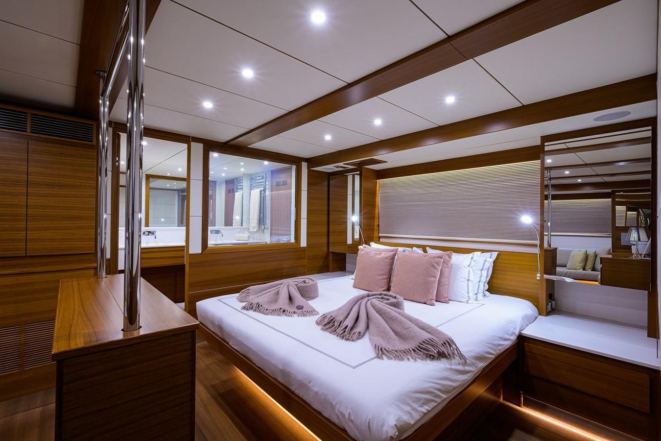 a room with a bed and a mirror aboard CHREEDO Yacht for Sale