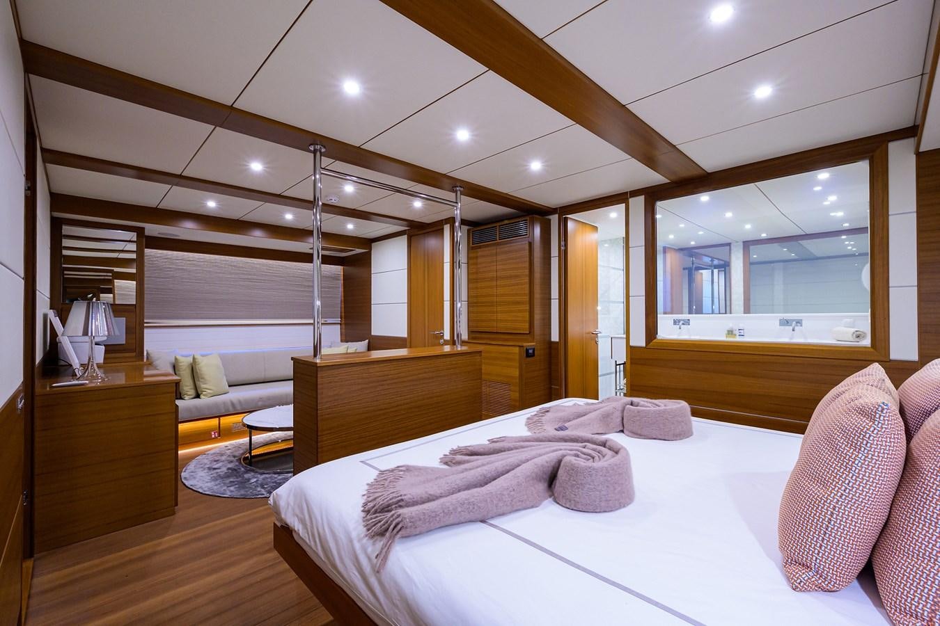 a bedroom with a bed and a desk aboard CHREEDO Yacht for Sale
