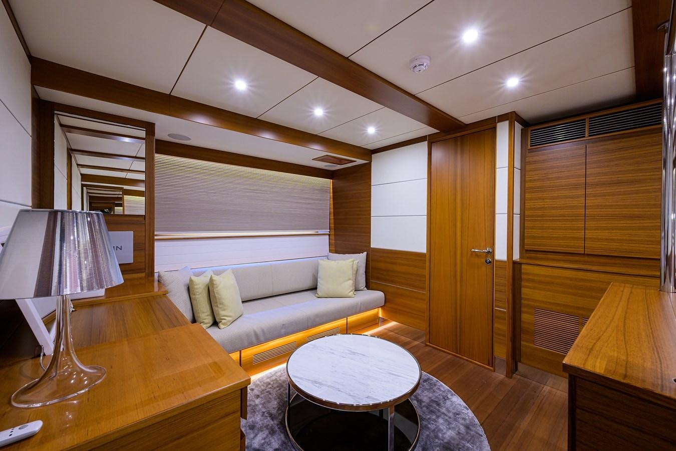 a living room with a couch and a table aboard CHREEDO Yacht for Sale